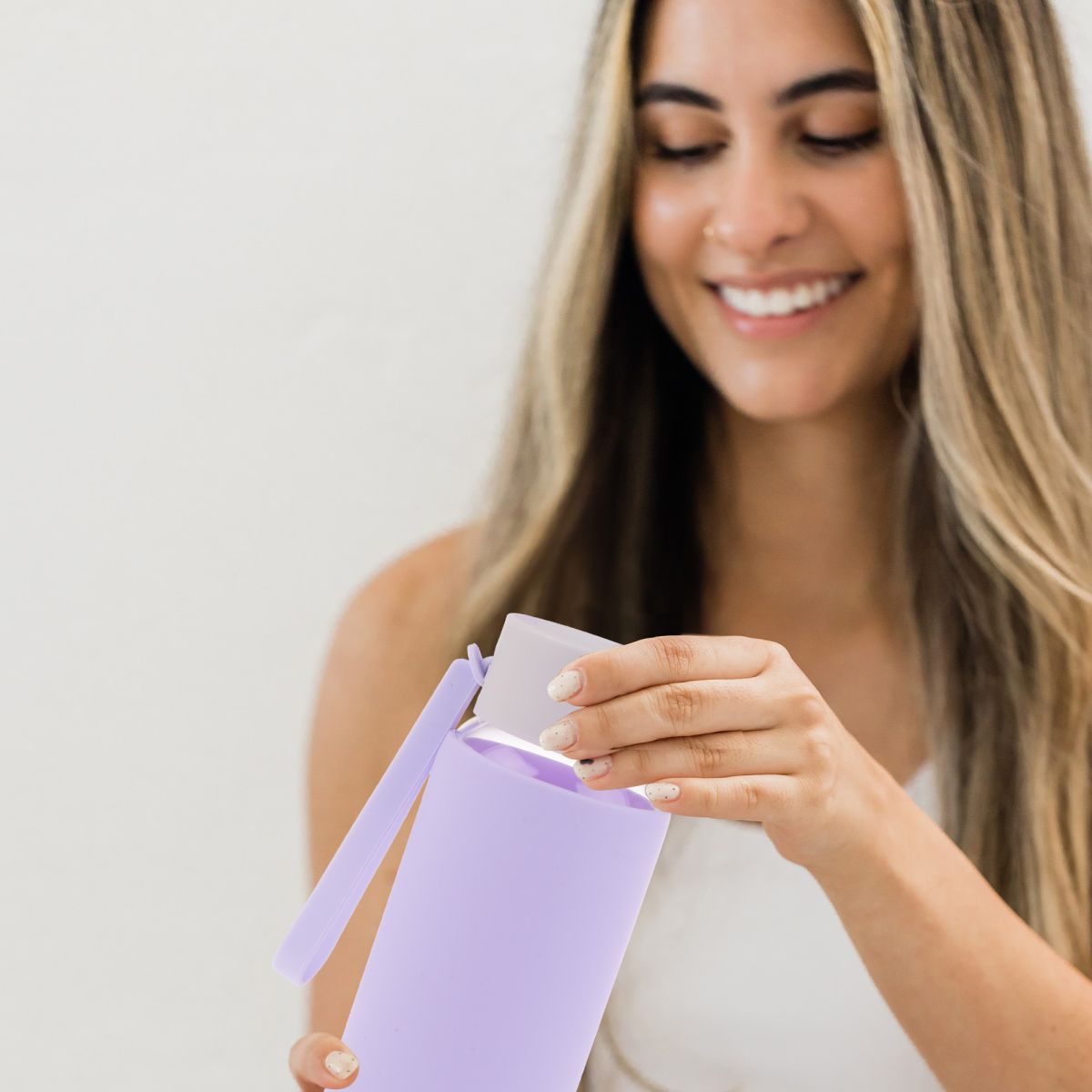 Image: Woman with a vorosilicate glass dirnk bottle